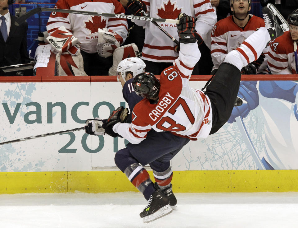 FILE - In this Feb. 28, 2010, file photo, USA's Joe Pavelski (16) and Canada's Sidney Crosby (87) go after a puck in the first period of the men's gold medal ice hockey game at the Vancouver 2010 Olympics in Vancouver, British Columbia. International Ice Hockey Federation chief Rene is encouraged upon learning the NHL’s tentatively agreed to labor deal opens the possibility of the league allowing its players to return to Olympic competition. Aside from the uncertainty raised by the global COVID-19 pandemic, Fasel told The Associated Press by phone Tuesday, July 7, 2020, he doesn’t foresee any major stumbling blocks that could derail negotiations leading up to the 2022 Beijing Games.(AP Photo/Julie Jacobson, File)