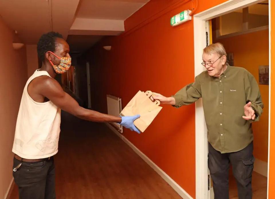 Received with thanks: Nigel Howat, 79, accepts his food parcel from Clarence Chodokufa: Nigel Howard