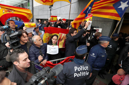 Demonstrators wave banners and flags as sacked Catalan leader Carles Puigdemont leaves a news conference at the Press Club Brussels Europe in Brussels, Belgium, October 31, 2017. REUTERS/Yves Herman