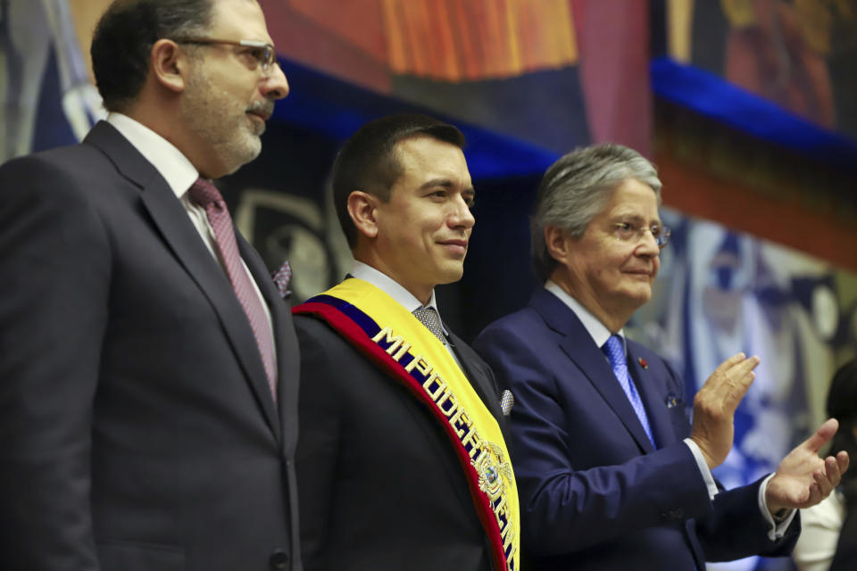 President Daniel Noboa, wearing the presidential sash, stands flanked by National Assembly President Henry Kronfle, left, and outgoing President Guillermo Lasso, during Noboa's swearing-in ceremony at the National Assembly, in Quito, Ecuador, Thursday, Nov. 23, 2023. AP Photo/Juan Diego Montenegro)