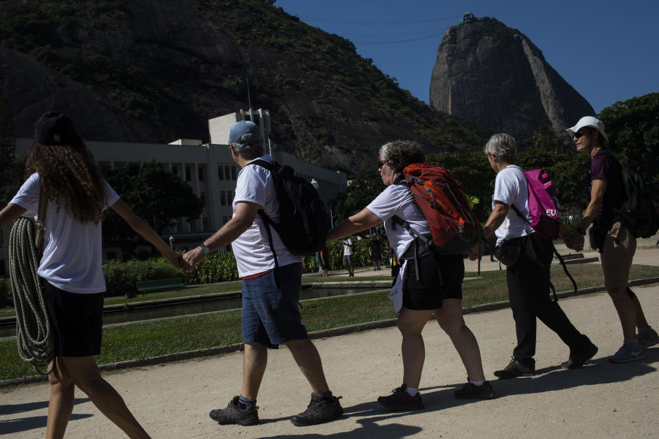 Residents and activists protest against the installation of a zip line on Sugar Loaf Mountain, an icon of the city and a UNESCO World Heritage Site, in Rio de Janeiro, Brazil, Sunday, March 26, 2023. (AP Photo/Bruna Prado)