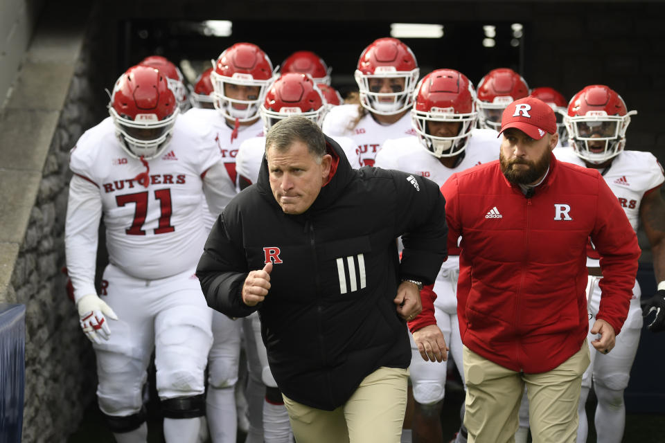 Rutgers head coach Greg Schiano leads his team onto the field for an NCAA college football game against Penn State in State College,Pa.,Saturday, Nov. 20, 2021. (AP Photo/Barry Reeger)