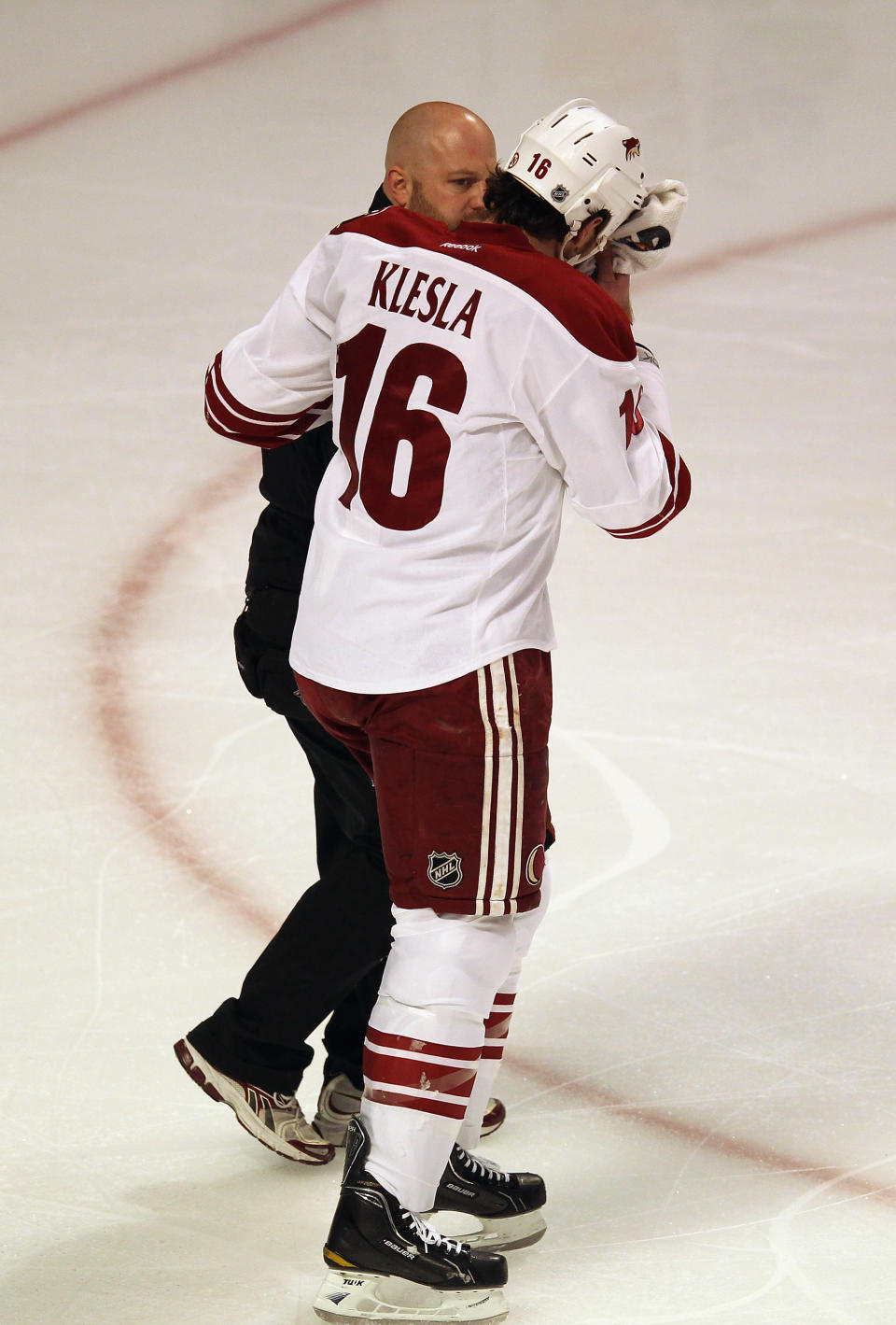 CHICAGO, IL - APRIL 23: Rostislav Klesla #16 of the Phoenix Coyotes is helped off of the ice after suffering a head injury in the first period against the Chicago Blackhawks in Game Six of the Western Conference Quarterfinals during the 2012 NHL Stanley Cup Playoffs at the United Center on April 23, 2012 in Chicago, Illinois. (Photo by Jonathan Daniel/Getty Images)