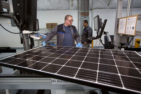 FILE PHOTO: Production operator John White checks a panel at the SolarWorld solar panel factory in Hillsboro, Oregon, U.S., January 15, 2018. REUTERS/Natalie Behring/File Photo