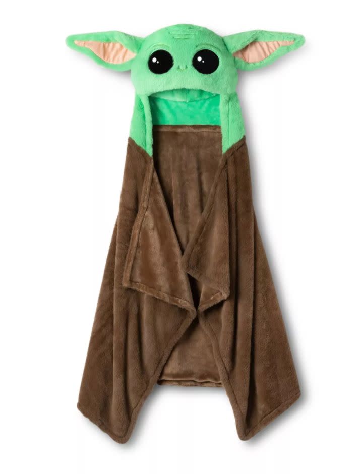 <a href="https://goto.target.com/c/2055067/81938/2092?u=https%3A%2F%2Fwww.target.com%2Fp%2Fstar-wars-the-mandalorian-the-child-hooded-blanket%2F-%2FA-79713122%3Fref%3Dtgt_adv_XS000000%26AFID%3Dgoogle_pla_df%26fndsrc%3Dtgtao%26DFA%3D71700000012806501%26CPNG%3DPLA_Bedding%252BShopping_Local%26adgroup%3DSC_Bedding_Local_NonBrand%26LID%3D700000001170770pgs%26LNM%3DPRODUCT_GROUP%26network%3Dg%26device%3Dc%26location%3D9004054%26targetid%3Dpla-952554208475%26ds_rl%3D1246978%26ds_rl%3D1247068%26ds_rl%3D1248099%26gclid%3DCjwKCAjw_sn8BRBrEiwAnUGJDhybfd7Bn0-sEyH6o0gfydHtAT3NTX4V5lrrUuIXIX2BK4s9YR9tqhoC25EQAvD_BwE%26gclsrc%3Daw.ds&amp;subid1=5&amp;subid2=babyyoda" target="_blank" rel="noopener noreferrer">Find it for $20 at Target</a>.