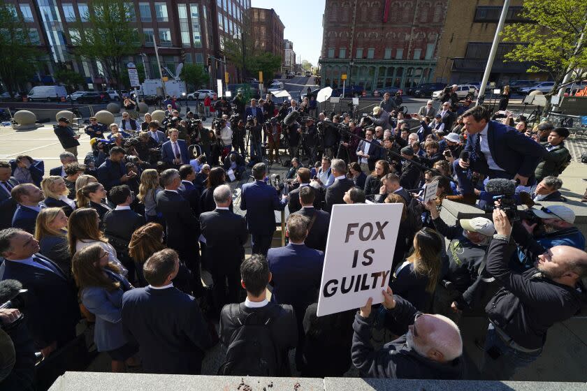 Attorneys for Dominion Voting Systems speak at a news conference outside New Castle County Courthouse in Wilmington, Del., after the defamation lawsuit by Dominion Voting Systems against Fox News was settled just as the jury trial was set to begin, Tuesday, April 18, 2023. (AP Photo/Julio Cortez)