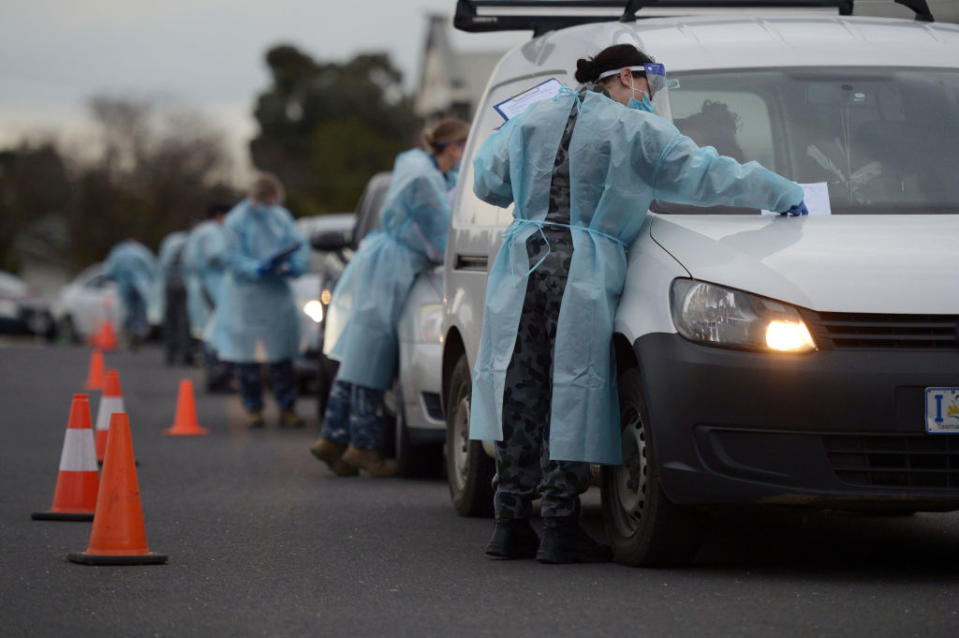 Members of the Australian Defence Force (ADF) gather information and conduct temperature checks at a drive-in Covid-19 testing site set up at the Melbourne Show Grounds in Melbourne, Victoria, Australia, on Tuesday, Jun 30, 2020. Victoria, Australia's second-most populous state, faces isolation from much of the country due to a spike in coronavirus cases that's jeopardizing the economic recovery. Photographer: Carla Gottgens/Bloomberg