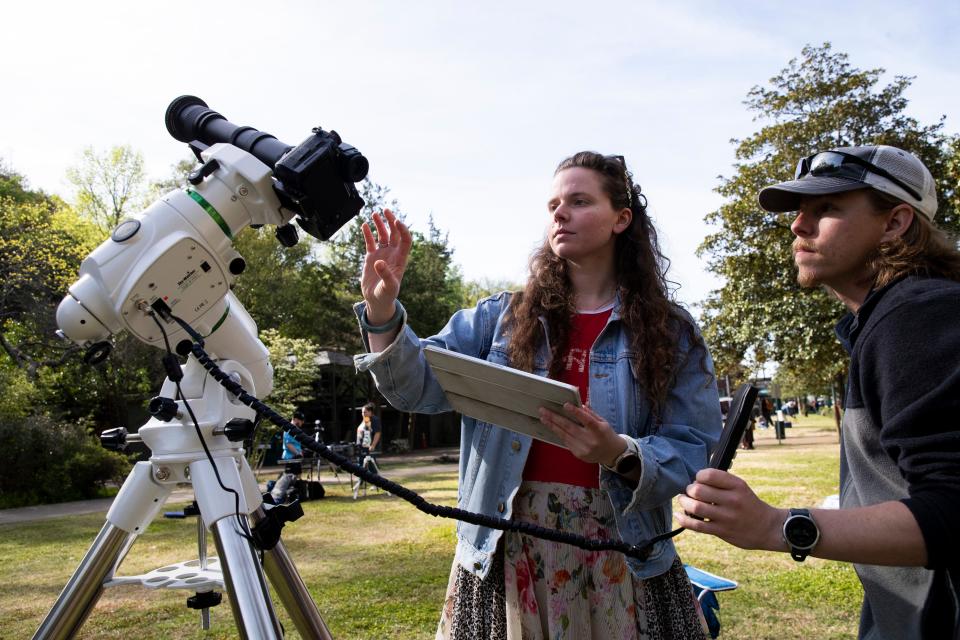 Faith Kjosa and Dustin Roberts set up their camera with a star tracker used for astrophotography to photograph the total solar eclipse on Arlington Lawn at Hot Springs National Park in Hot Springs, Arkansas, on April 8, 2024.