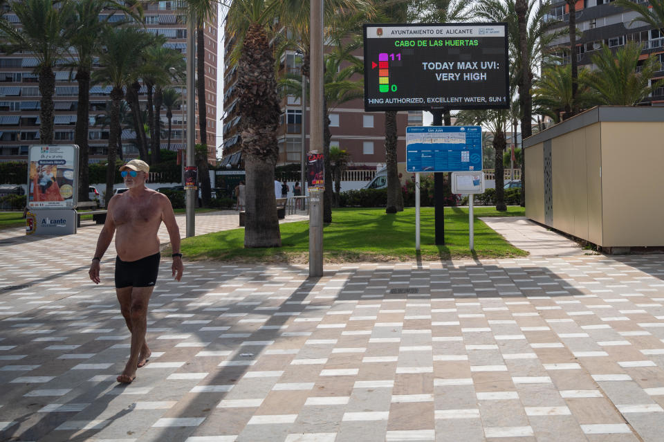 A sign warns of very high ultraviolet radiation during a hot summer day at San Juan Beach in Alicante, Spain, amid red warnings for extremely high temperatures caused by a heat wave dubbed 
