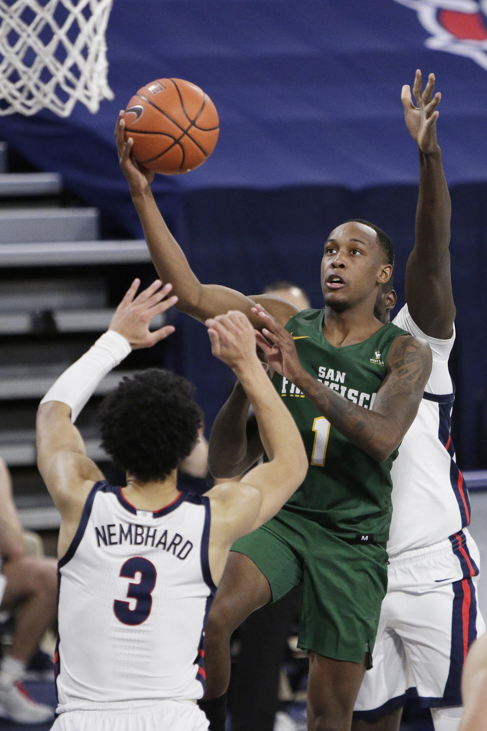 San Francisco guard Jamaree Bouyea (1) shoots over Gonzaga guard Andrew Nembhard (3) during the first half of an NCAA college basketball game in Spokane, Wash., Saturday, Jan. 2, 2021. (AP Photo/Young Kwak)