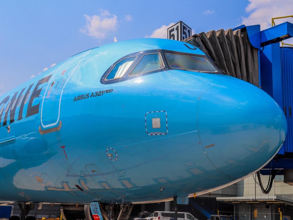 The front of a La Compagnie Airbus A321neo at an airport.