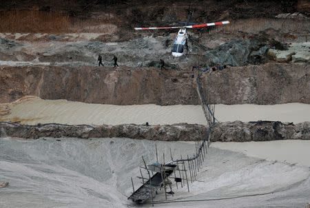 Specialised inspectors take a position at an illegal gold mine during an operation conducted by agents of the Brazilian Institute for the Environment and Renewable Natural Resources, or Ibama, in national parks near Novo Progresso, southeast of Para state, Brazil, November 5, 2018. REUTERS/Ricardo Moraes