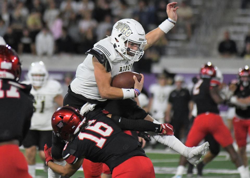 Rider's Jack Pitts tries to hurdle a Lubbock-Cooper defender in the Region I-5A Division II final Friday, Dec. 3, 2021, at Wildcat Stadium in Abilene.