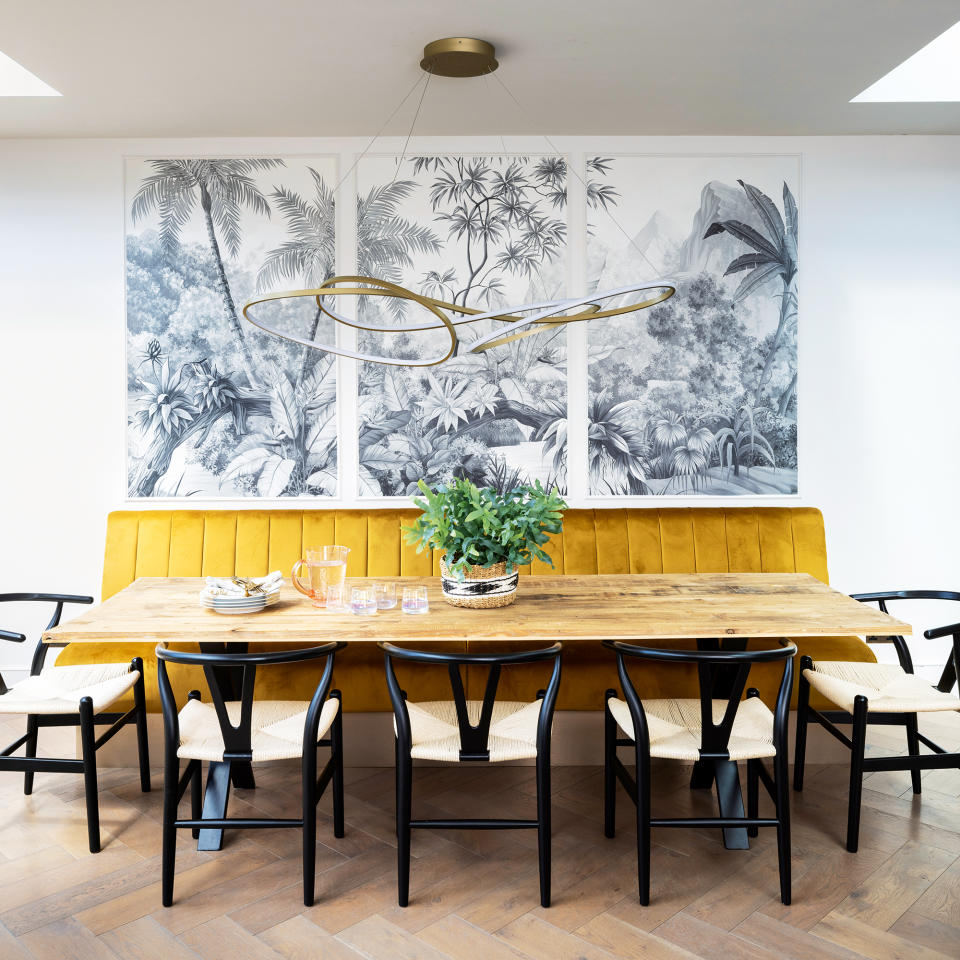  Dining room with wooden parquet flooring, ochre bench and three panelled mural 