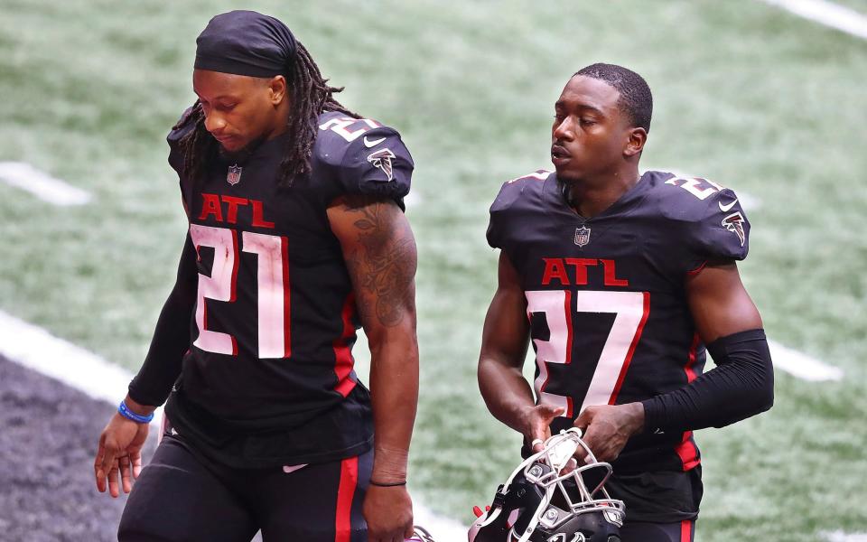 Atlanta Falcons running back Todd Gurley, left, and Damontae Kazee walk off the field after losing to the Chicago Bears in an NFL football game on Sunday, Sept. 27, 2020 in Atlanta. - AP