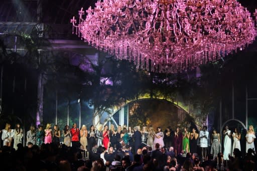 The biggest amount -- 1.6 million euros -- raised was for a collection of designer dresses modelled by a bevy of catwalk stars. A bidding war erupted after the models offered to each bestow a kiss on the winner