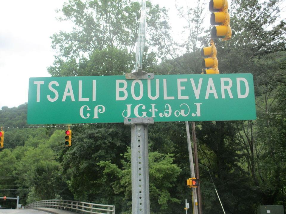 One of many road signs in Cherokee town marking the central Tsali Boulevard. The sign is written in both the Cherokee syllabary and English.