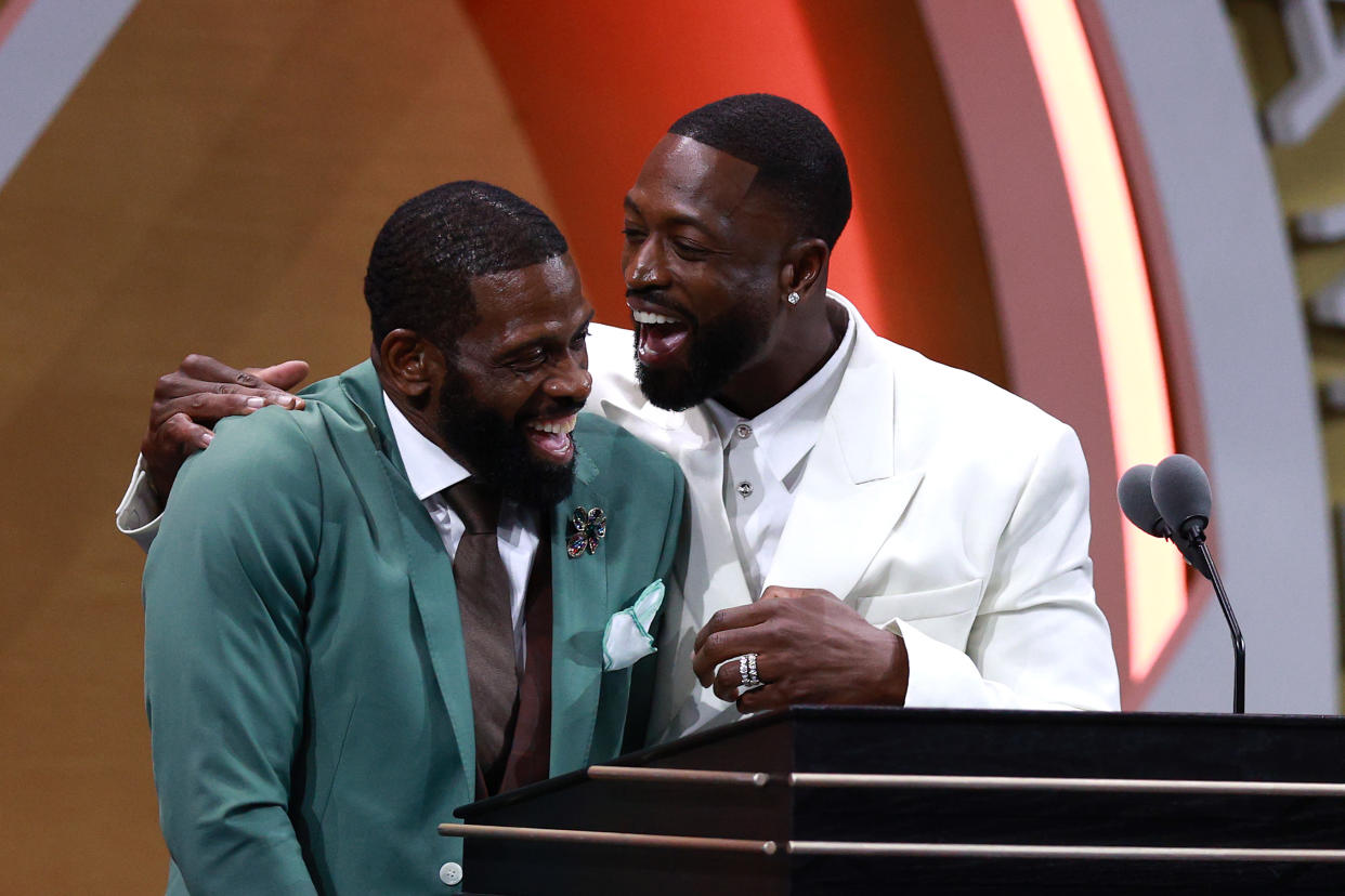 Naismith Memorial Basketball Hall of Fame Class of 2023 inductee Dwyane Wade speaks on stage with his father, Dwyane Wade Sr, during the induction ceremony at Symphony Hall in Springfield, Massachusetts, on Aug. 12, 2023. (Mike Lawrie/Getty Images)