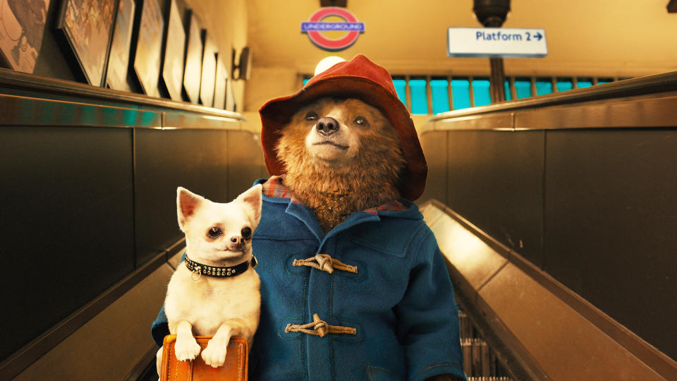 Paddington Bear rides an escalator