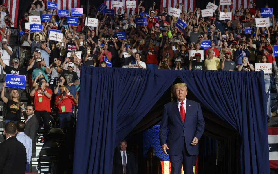 Donald Trump enters the stage at a Save America Rally