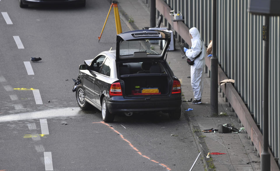 An investigator works on the scene, following several accidents on the city motorway A100 in Berlin, Germany, Wednesday, Aug. 19, 2020. According to German news agency dpa, prosecutors say a series of crashes caused by a 30-year-old Iraqi man on the highway late Tuesday night was an Islamic extremist attack. (Paul Zinken/dpa via AP)