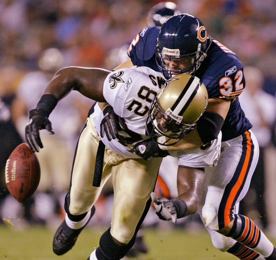 FILE - Chicago Bears' Todd Johnson (32) forces New Orleans Saints' Boo Williams (82) to fumble during the first quarter Friday, Aug. 27, 2004, in Chicago.