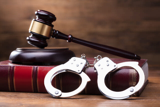 A Gavel and Handcuffs on a Desk