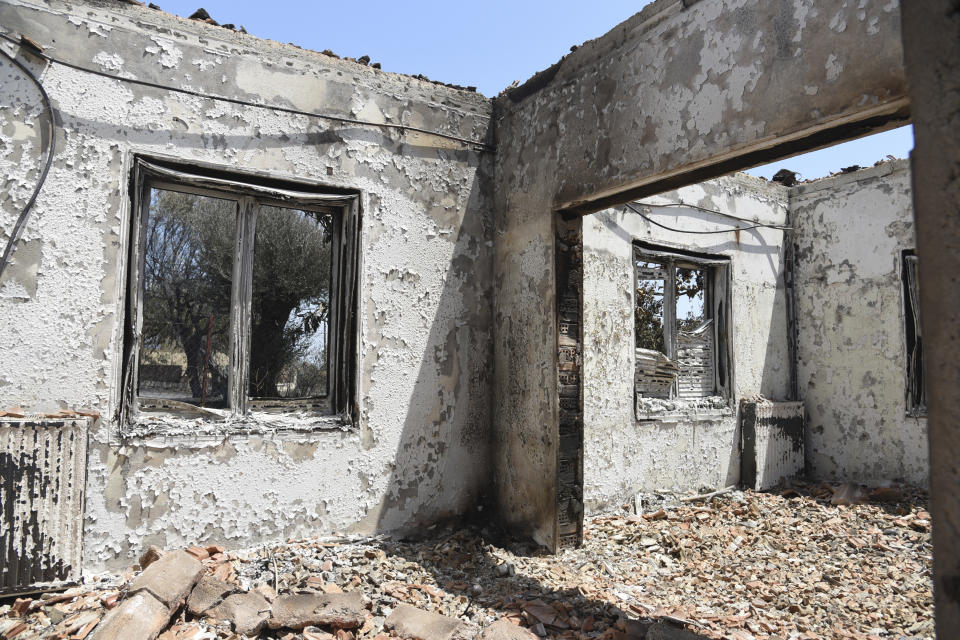 A burned house in Ziria village, east of Patras, Greece, Sunday, Aug. 1, 2021. A wildfire that broke out Saturday in western Greece forced the evacuation of four villages and people on a beach by the Fire Service, the Coast Guard and private boats, authorities said. (AP Photo/Andreas Alexopoulos)