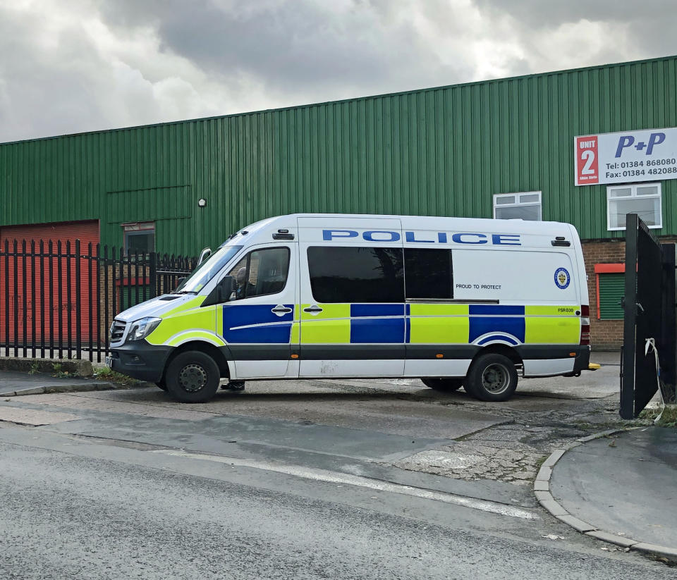 A police vehicle blocking an entrance to Albion Works industrial estate in Brierley Hill, West Midlands, in the area where two men were found shot dead in a car on Wednesday afternoon.