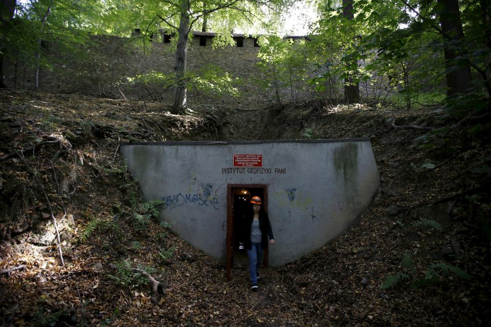 A woman walks out from the entrance of tunnels, which are part of the Nazi Germany "Riese" construction project, now used by the Institute of Geophysics, Polish Academy of Sciences (PAN) under the Ksiaz castle in an area where a Nazi train is believed to be, in Walbrzych, southwestern Poland September 3, 2015. Poland said on Friday it was almost certain it had located the Nazi train rumored to have gone missing near the close of World War Two loaded with guns and jewels. Photographs taken using ground-penetrating radar equipment showed a train more than 100 metres (330 feet) long, the first official confirmation of its existence, Deputy Culture Minister Piotr Zuchowski said. REUTERS/Kacper Pempel