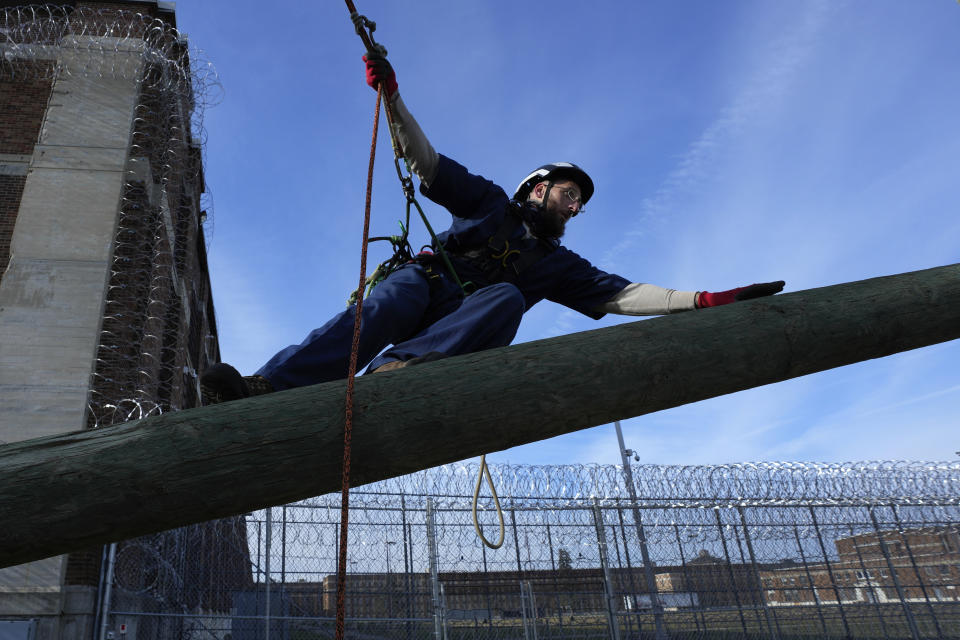 Prisoner Scott Steffes works on climbing at the Parnall Correctional Facility's Vocational Village in Jackson, Mich., Thursday, Dec. 1, 2022. Steffes, 37, whose release date is Jan. 17, 2023, is one of more than a dozen prisoners learning how to climb trees and trim branches around power lines as part of DTE Energy's plan to improve the utility's electric infrastructure. (AP Photo/Paul Sancya)