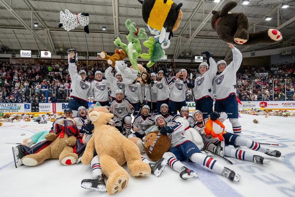 The Tri-City Americans throw plushies into the air while gathering for a team picture Saturday, Dec. 9 at the Toyota Center in Kennewick, Wash. Stuffed animals littered the ice for the team’s 23rd annual Teddy Bear Toss.