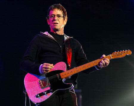 U.S. musician Lou Reed plays the guitar during his concert in Santiago de Compostela in this July 16, 2004 file photograph. REUTERS/Miguel Vidal/Files