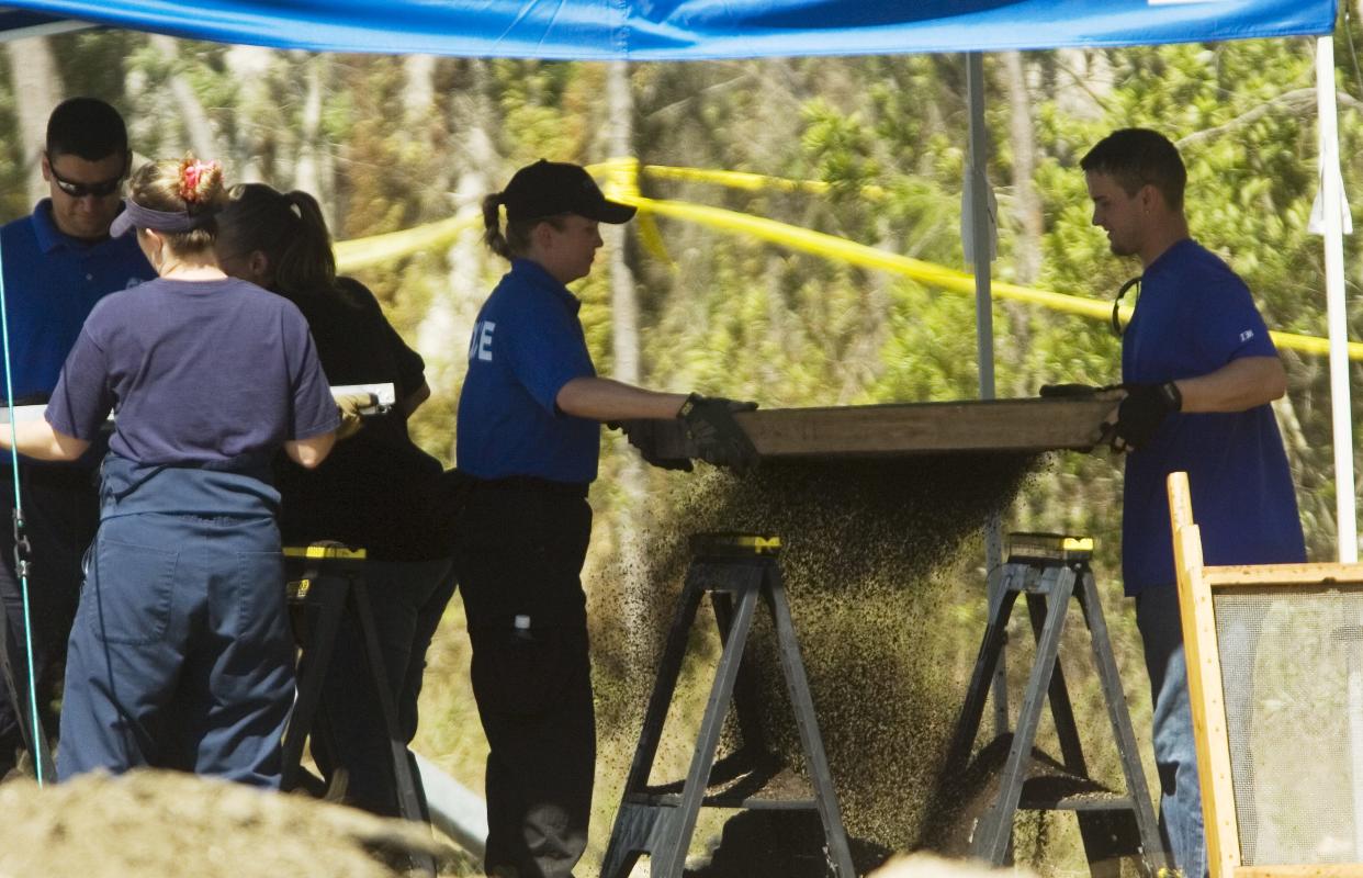 In this News-Press file photo, investigators with the Florida Department of Law Enforcement and the Fort Myers Police Department sift through dirt that was found at the remains of eight bodies found off of Arcadia Street in Fort Myers on Friday, March 23, 2007. The bodies of eight men were uncovered; with police announcing on Tuesday, Sept. 6, 2022, that a fourth one has been identified.