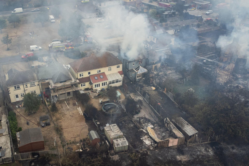 WENNINGTON, GREATER LONDON - JULY 19: In this aerial view, smoke from fires in a residential area being fought by fire services are seen on July 19, 2022 in Wennington, England. A series of grass fires broke out around the British capital amid an intense heatwave.<span class="copyright">Getty Images—2022 Getty Images</span>