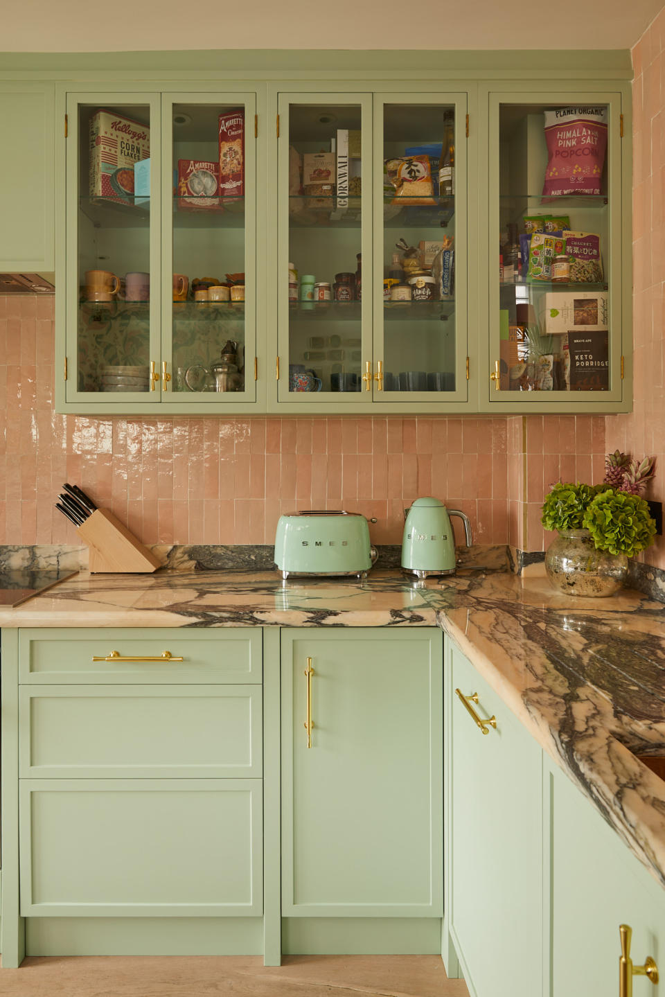 Green kitchen with pink tiles