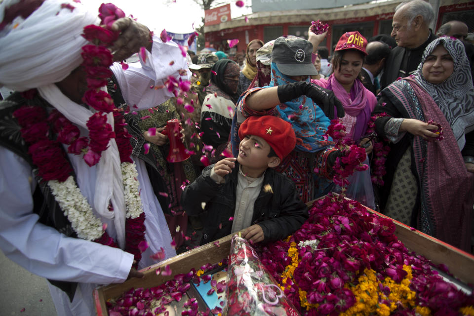 People welcome the family members of missing people during a march in Rawalpindi, Pakistan, Friday, Feb. 28, 2014. Affected families walked nearly 3,000 kilometers to reach capital Islamabad and register protest against the abductions and killings of their loved ones by Pakistani security agencies without producing them in court of law. (AP Photo/B.K. Bangash)