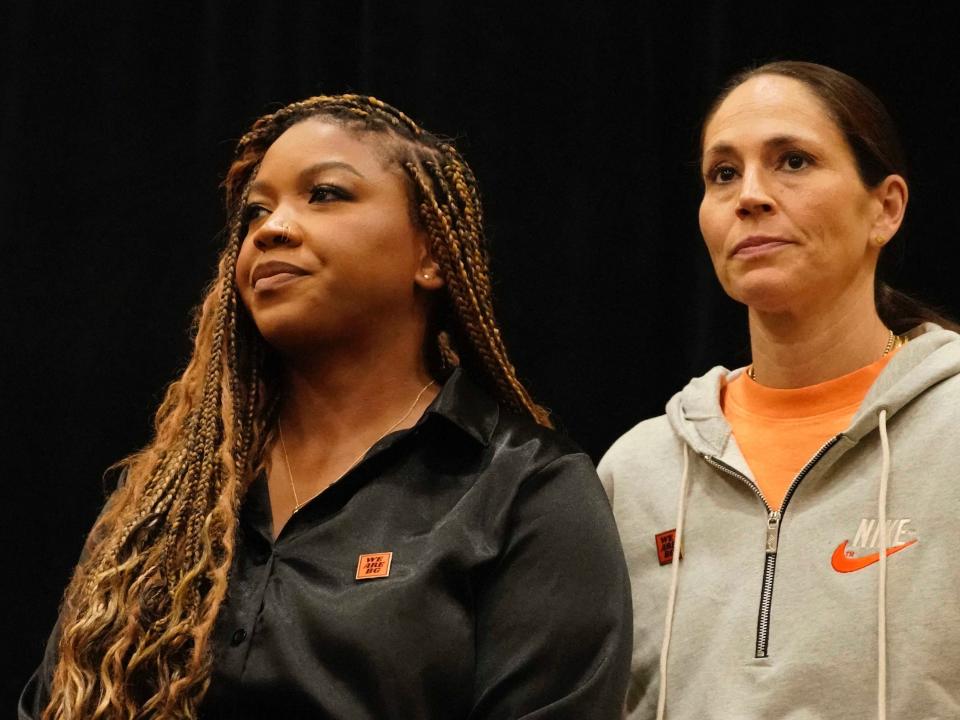 Sue Bird (right) stands alongside Cherelle Griner during a press conference.