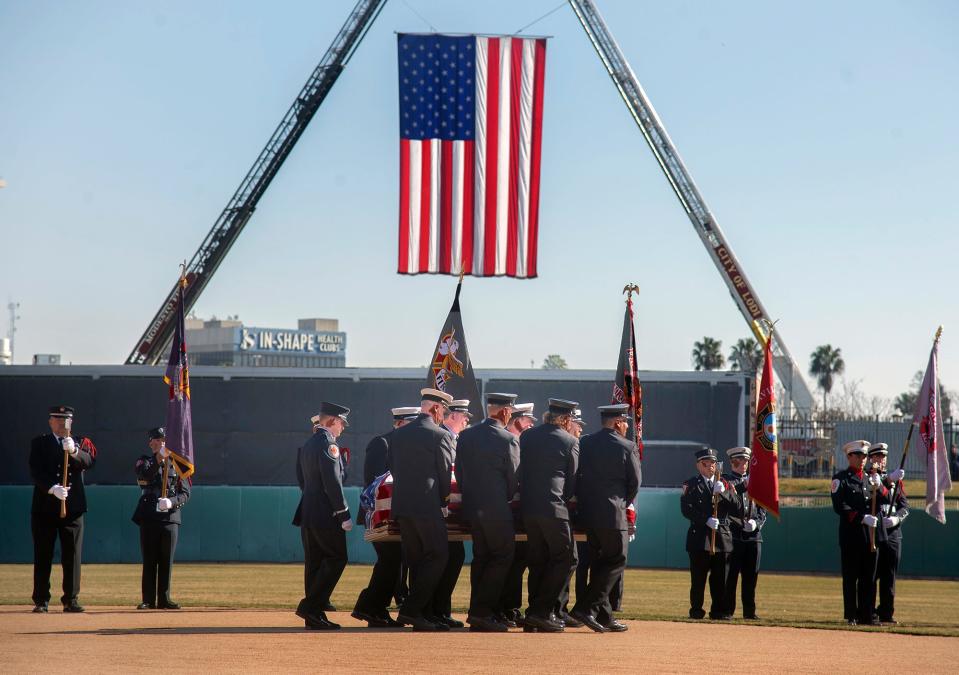 Pall bearers carry out the casket at the end of a memorial service for slain Stockton Fire captain Vidal "Max" Fortuna at the Stockton Ballpark in downtown Stockton on February, 8, 2022.