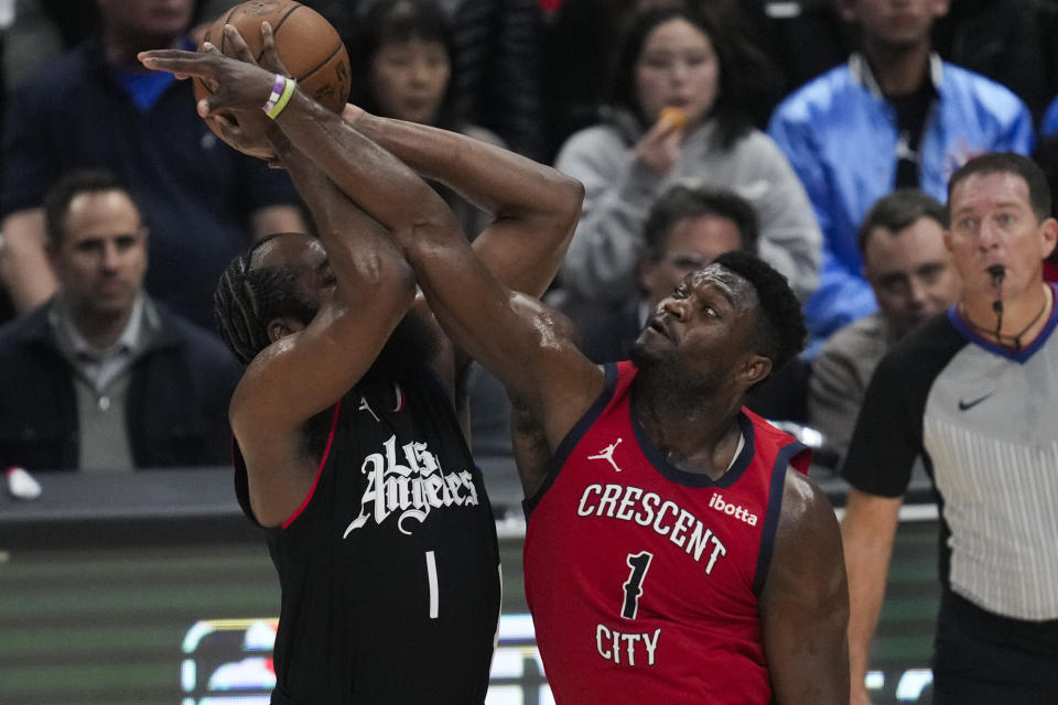 New Orleans Pelicans forward Zion Williamson, right, fouls Los Angeles Clippers guard James Harden during the first half of an NBA basketball game in Los Angeles, Wednesday, Feb. 7, 2024. (AP Photo/Ashley Landis)