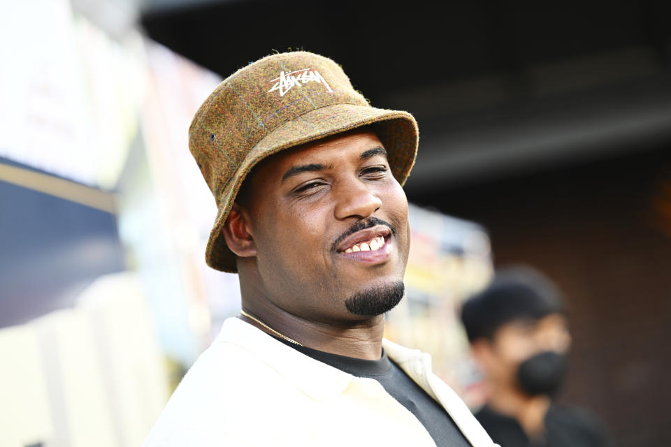 Lionel Boyce at the premiere of FX's The Bear wearinf a bucket hat. Lionel has a mustache and a goatee