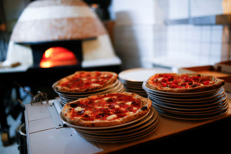 Pizza is prepared inside the Apollo Pizzeria, in London, Britain, January 22, 2019. REUTERS/Henry Nicholls