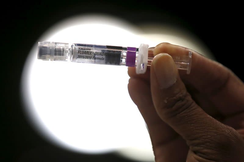 FILE PHOTO: A nurse displays a flu vaccine at a free medical and dental health clinic in Los Angeles