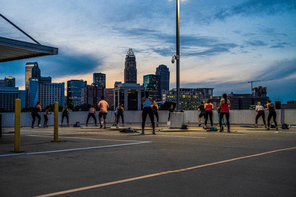 Sweatnet’s outdoor workouts are full of variety, including bootcamp, barre, HIIT and more. Shown here is a sunset rooftop yoga class.