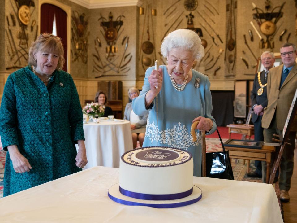 Queen Elizabeth putting a knife into her Platinum Jubilee cake at Sandringham House