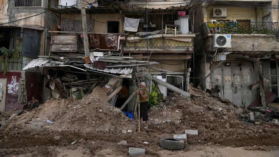 A Palestinian refugee stands in front of his shop that was partly destroyed during the Israeli army operation in Tulkarem, West Bank, on Thursday. - Nasser Nasser/AP