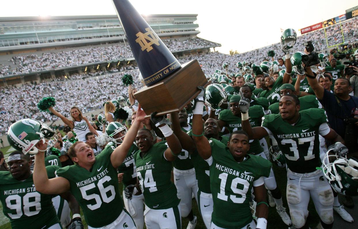 Michigan State players celebrate with the Megaphone Trophy after their 23-7 victory over Notre Dame at Spartan Stadium on Saturday, September 20, 2008 in East Lansing.