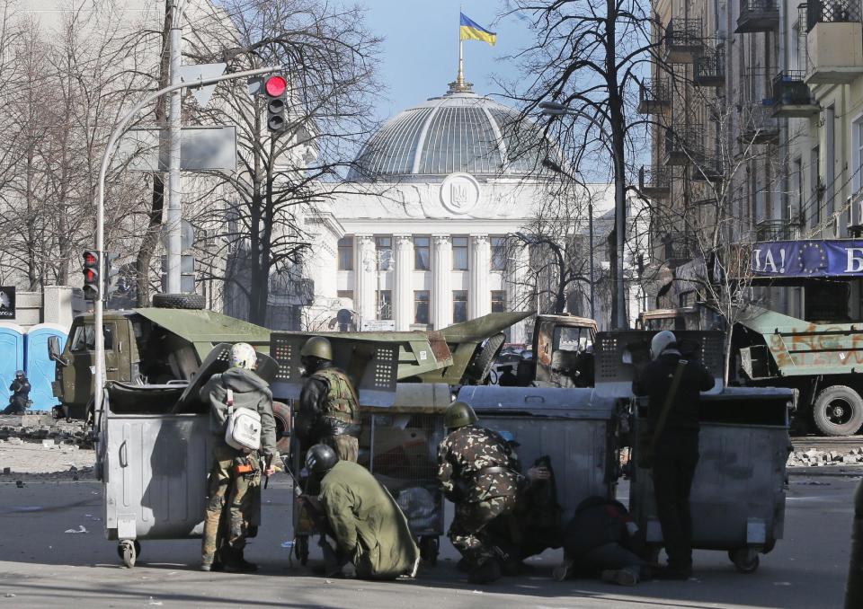 Anti-government protesters clash with riot police outside Ukraine's parliament in Kiev, Ukraine, Tuesday, Feb. 18, 2014. Ukraine’s political crisis escalated sharply Tuesday, with at least nine people reported killed and scores injured in violent, often fiery battles between anti-government demonstrators and police in Kiev. The clashes outside parliament erupted after the opposition accused the government of ignoring its demands even after nearly three months of protests that have paralyzed the capital. It was the worst violence since the protests began in late November. (AP Photo/Efrem Lukatsky)