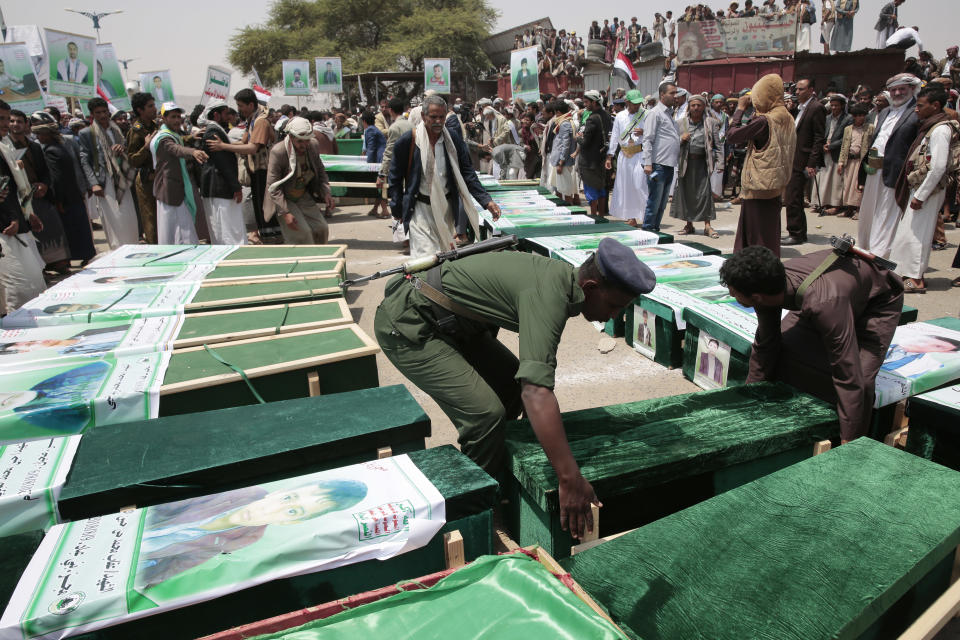 Yemeni people attend the funeral of victims of a Saudi-led airstrike, during a funeral in Saada, Yemen, Monday, Aug. 13, 2018. Yemen's shiite rebels are backing a United Nations' call for an investigation into the airstrike in the country's north that killed dozens of people including many children. (AP Photo/Hani Mohammed)