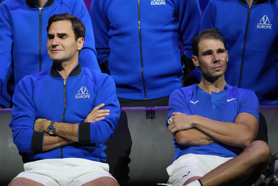 An emotional Roger Federer, left, of Team Europe sits alongside his playing partner Rafael Nadal after their Laver Cup doubles match against Team World's Jack Sock and Frances Tiafoe at the O2 arena in London, Friday, Sept. 23, 2022. Federer's losing doubles match with Nadal marked the end of an illustrious career that included 20 Grand Slam titles and a role as a statesman for tennis. (AP Photo/Kin Cheung)